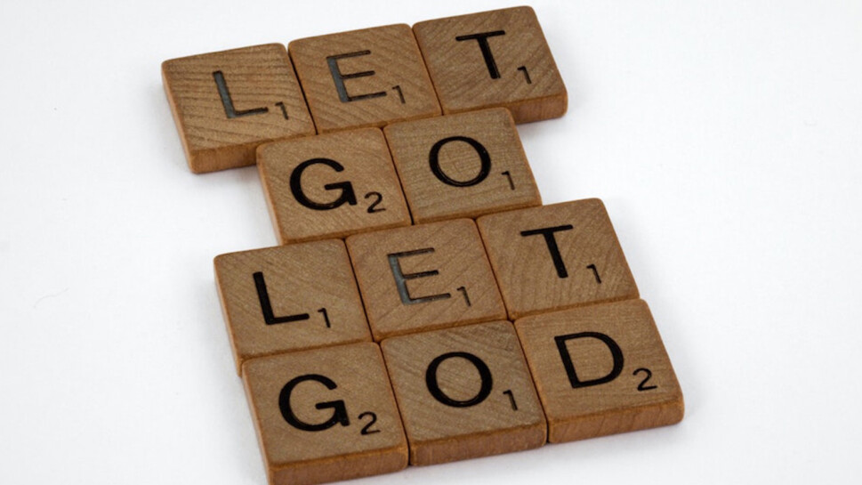Wooden scrabble pieces that spell 'Let go let God'