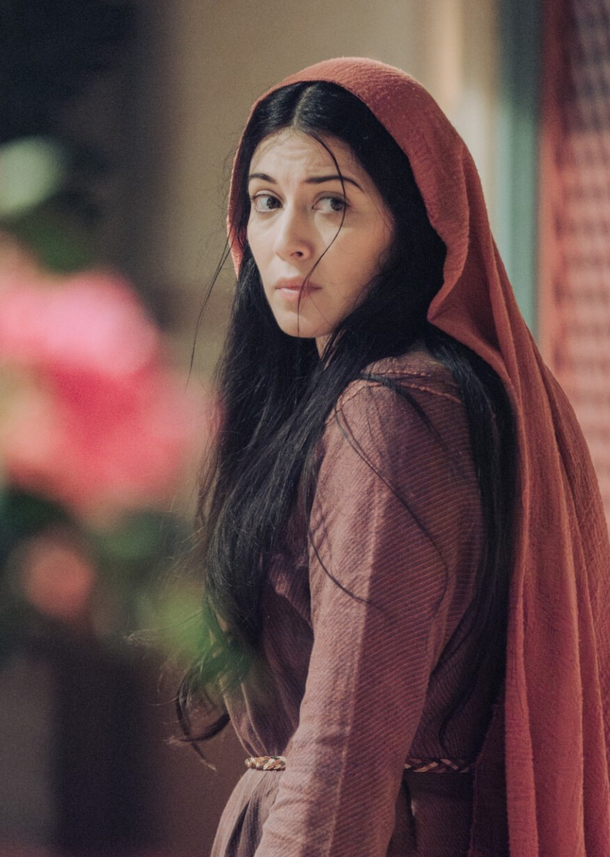 Mary Magdalene, looking anxiously over her shoulder