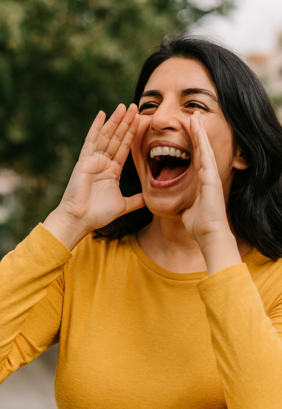 Woman smiling, shouting for someone