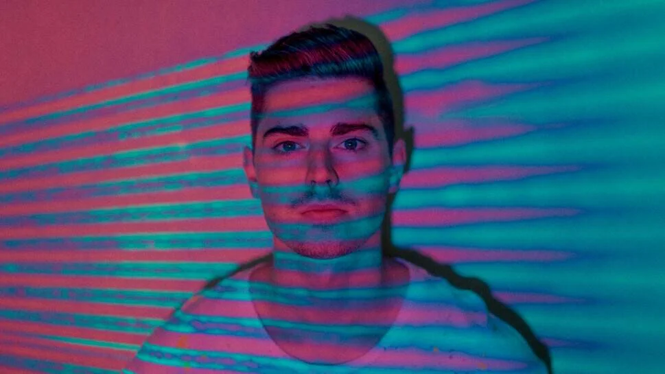 man with pink and blue light